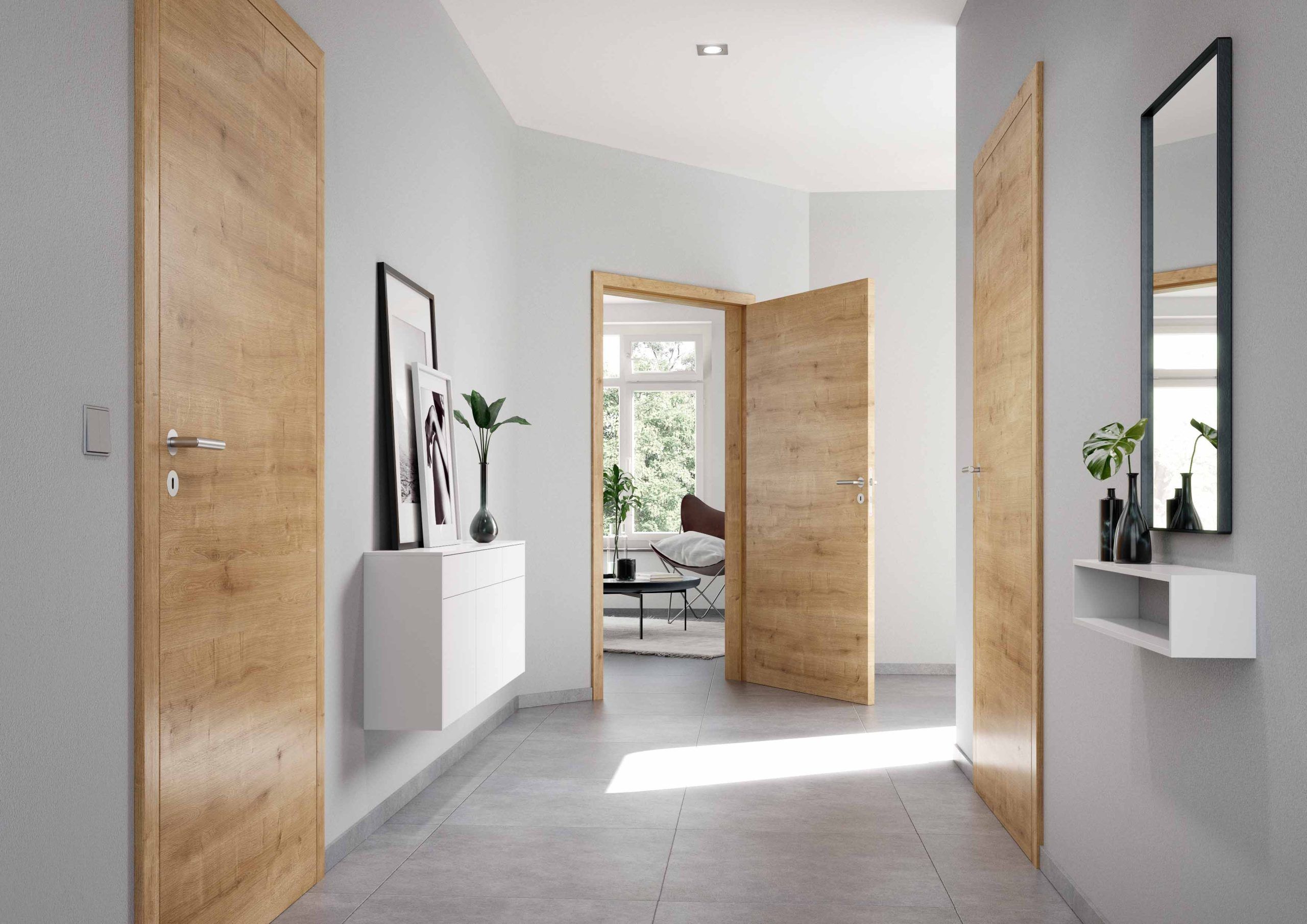 Hall moderne avec portes en bois, plantes, miroirs et lumière naturelle, créant une ambiance accueillante.