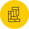 Icône circulaire jaune avec un motif de blocs imbriqués, symbolisant la construction ou l'assemblage.